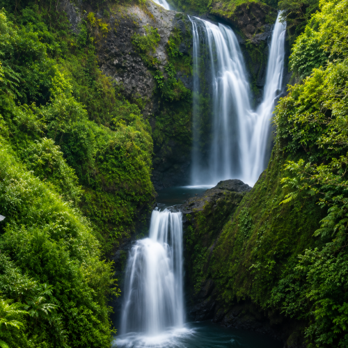 Magnificent tropical waterfall nestled within the lush rainforest of Toraja, offering a serene nature escape in South Sulawesi, Indonesia.