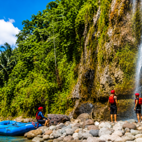 Professional rafting guides leading visitors through exciting river rapids surrounded by lush tropical forest in Toraja, South Sulawesi.